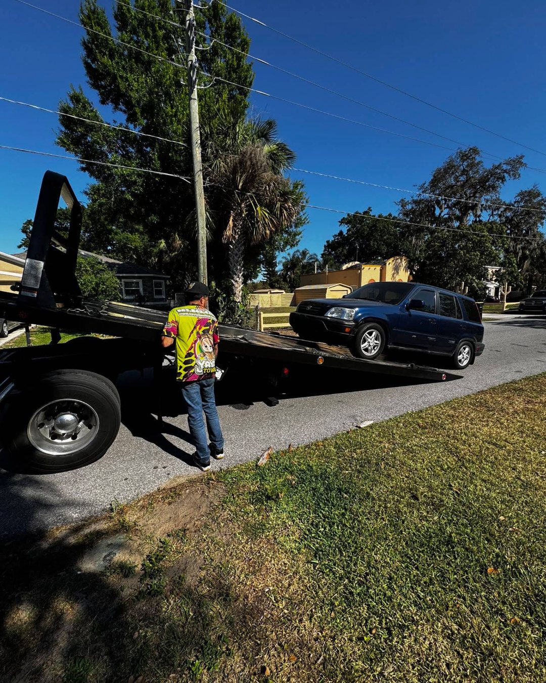 Yayi’s Towing driver loading an SUV onto the flatbed in Auburndale, FL